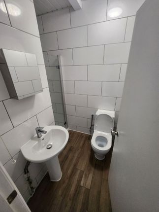A Clean, Modern Bathroom With White Tiled Walls An...