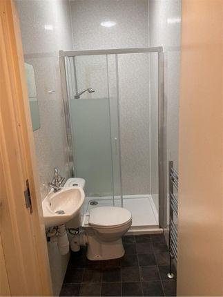 A Clean And Functional Bathroom Featuring A Shower...