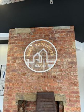 Exposed Brick Feature Wall With Mounted Circular c...