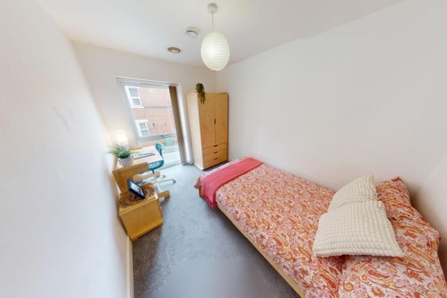 A Bright And Tidy Single Bedroom Featuring A Comfo...