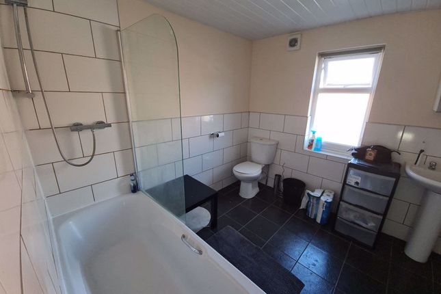 A Spacious Bathroom Featuring A Bathtub, Large Win...