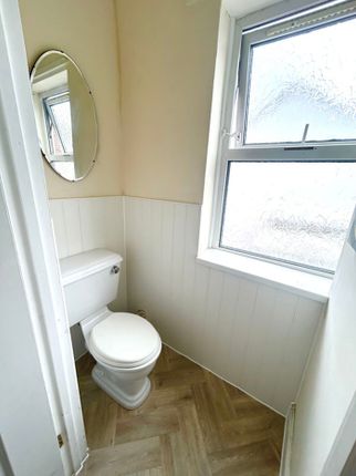 A Bright And Tidy Single Toilet Featuring A Modern...