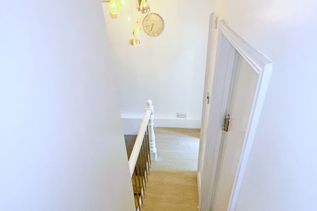 A Well-Lit And Clean Staircase Featuring Modern li...