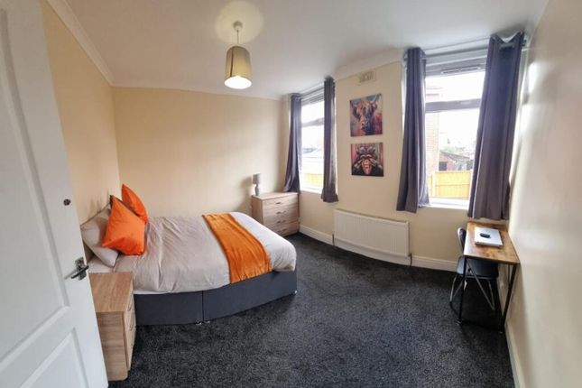 This Inviting Double Bedroom Features A Comfortabl...