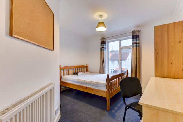 A Bright And Inviting Master Bedroom With A Wooden...