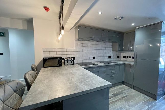 This Modern Kitchen Features Sleek Grey Cabinetry ...
