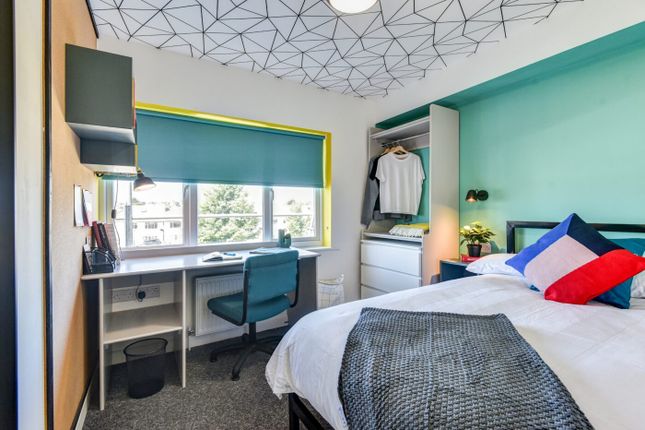 Bright And Stylish Bedroom Featuring A Large Windo...