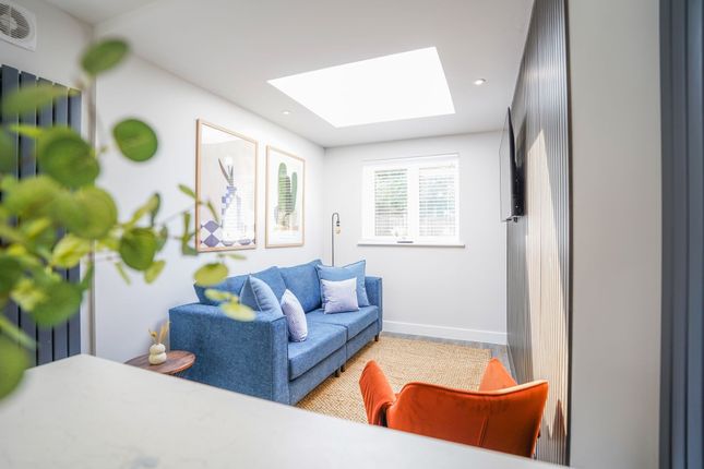 Bright And Modern Living Room Featuring A Cozy Blu...