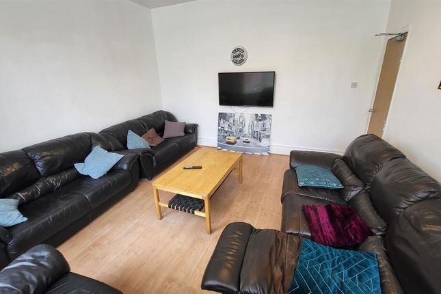 A Comfortable Living Room Featuring Multiple Black...