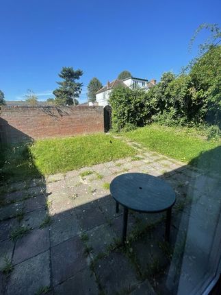 Bright And Sunny Garden Area Featuring A Paved Pat...