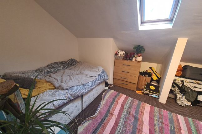 Cozy Bedroom Featuring A Skylight That Provides Na...