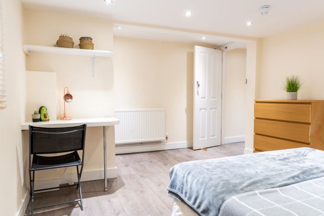 This Inviting Double Bedroom Features A Comfortabl...