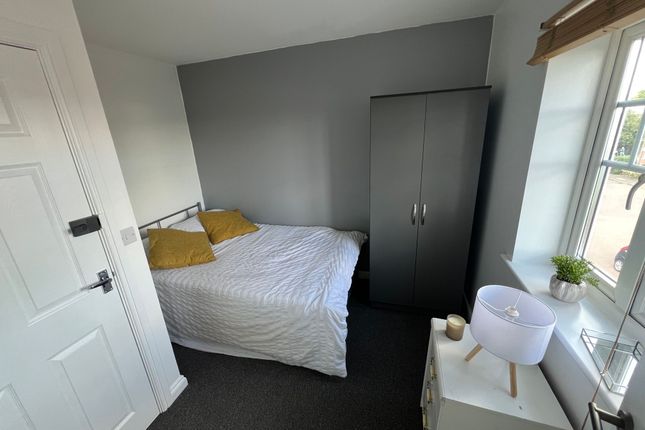 A Cozy Double Bedroom Featuring A Comfortable Doub...