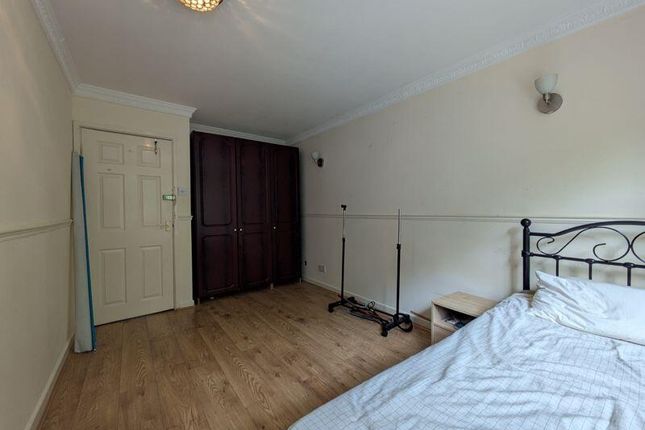 A Neat Bedroom Featuring A Single Bed With A Metal...