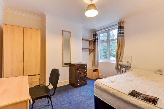 A Well-Lit Bedroom Featuring A Comfortable Double ...