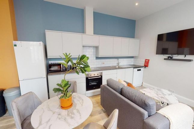 A Modern Kitchenette With Ample Space And Bright l...