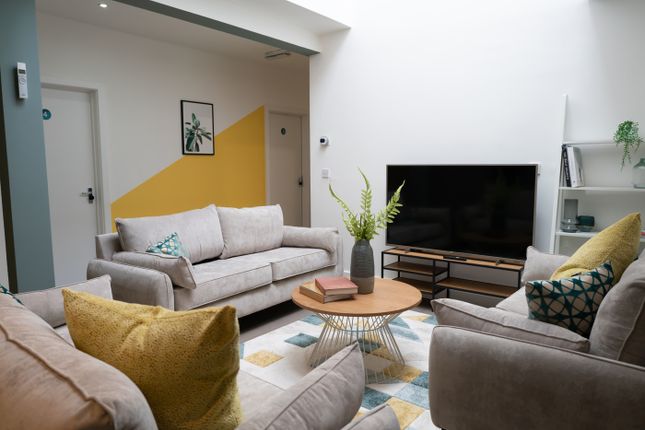 A Spacious And Inviting Living Room Featuring Comf...