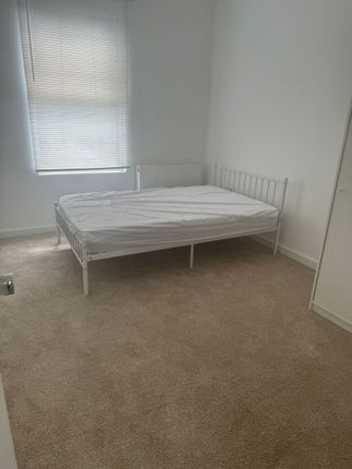 A Bright And Tidy Double Bedroom With Neutral Carp...