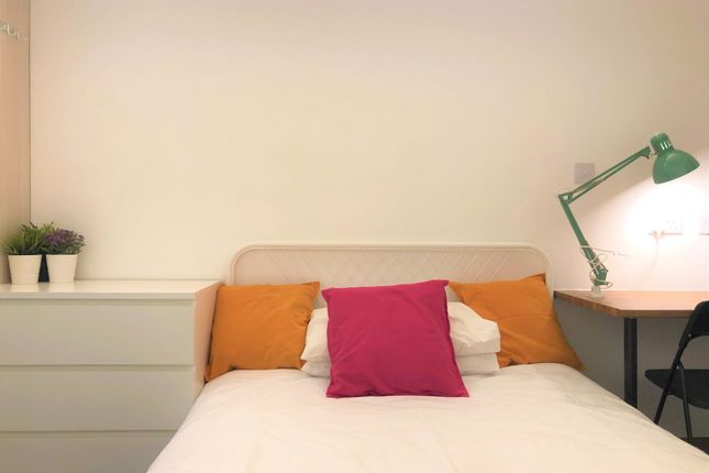 A Cozy And Tidy Single Bedroom Featuring A Comfort...