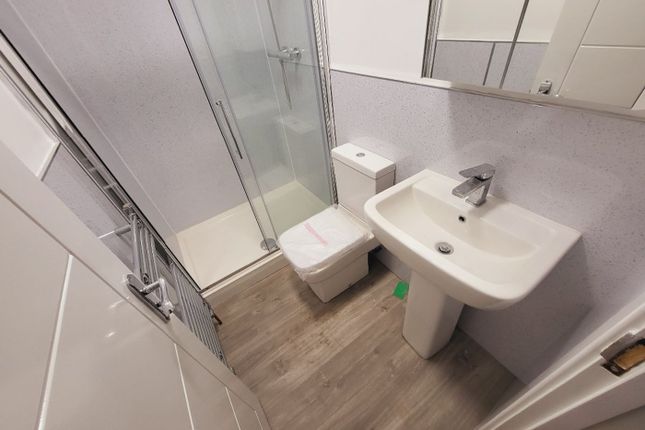 A Modern Bathroom Featuring A Sleek Shower, Contem...