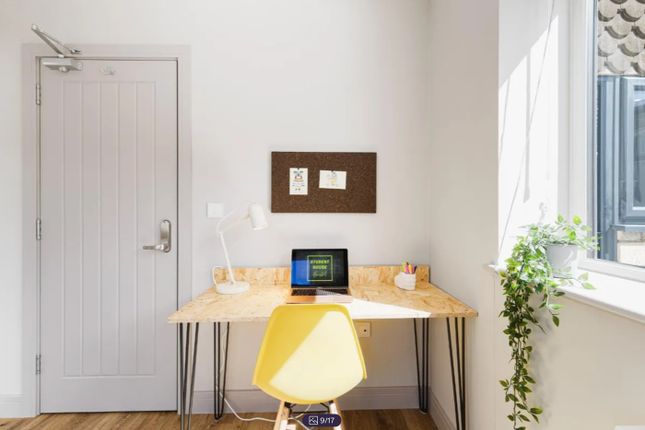 A Bright And Inviting Communal Workspace Featuring...