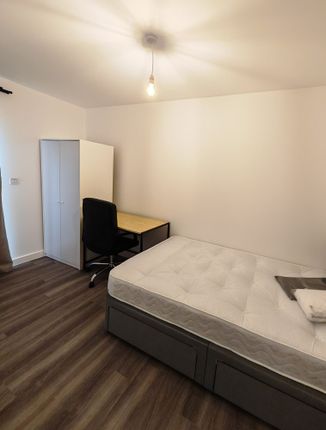 A Neat And Simple Single Bedroom Featuring A Comfo...