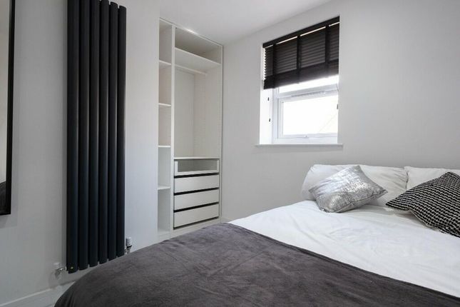 A Modern And Tidy Bedroom Featuring A Double Bed, ...