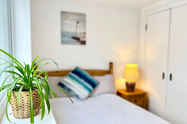 A Cozy Double Bedroom Featuring A Comfortable Bed ...