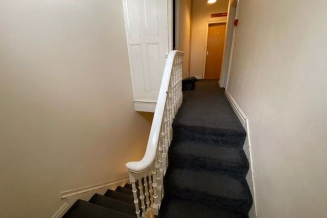 A Clean And Well-Maintained Hallway Featuring A Ca...