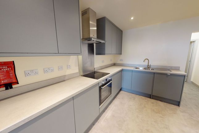 A Modern, Light-Filled Kitchen With Sleek Grey Cab...
