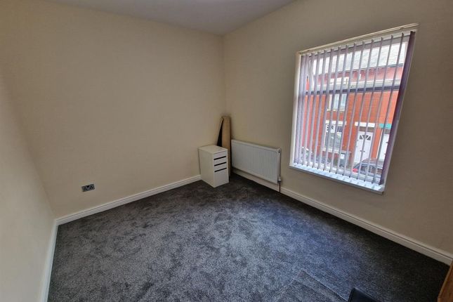 A Small And Clean Room With Carpeted Flooring, A R...