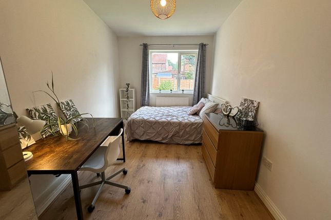 This Inviting Double Bedroom Features A Comfortabl...