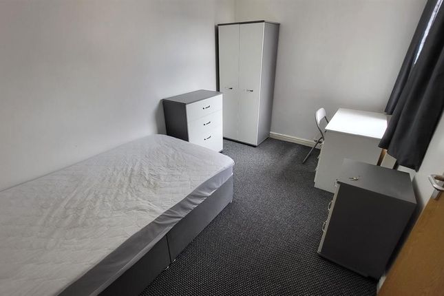 A Simple And Tidy Single Bedroom Featuring A Clean...