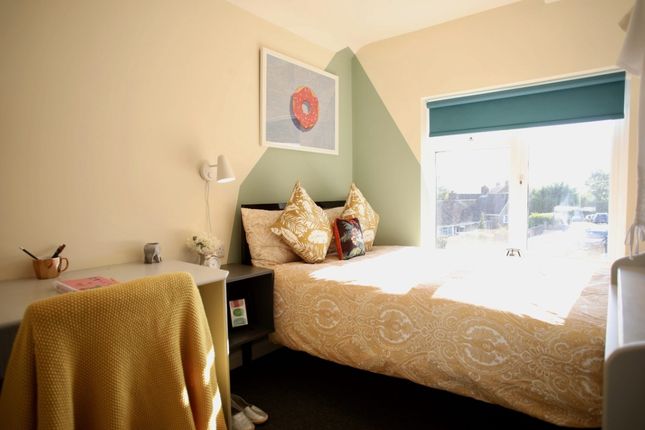 This Charming Double Bedroom Features A Cozy Bed A...