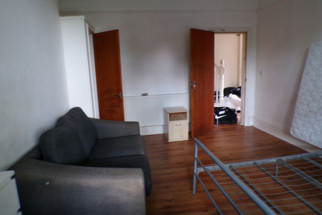 A Spacious Double Bedroom Featuring A Cozy Sofa, P...