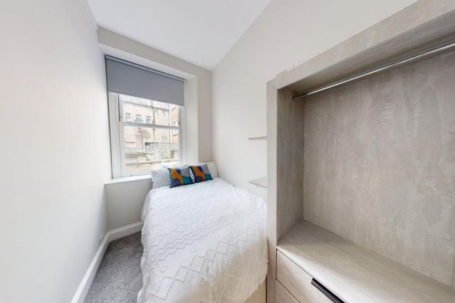 A Bright And Tidy Single Bedroom With Modern Decor...