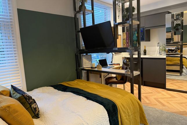 A Stylish Master Bedroom Featuring A Comfortable d...
