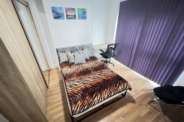 A Stylish Double Bedroom Featuring A Comfortable B...