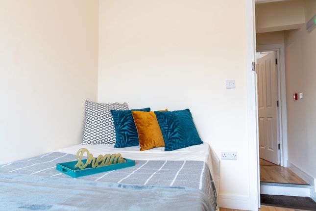 A Cozy Double Bedroom Featuring Soft, Inviting Dec...