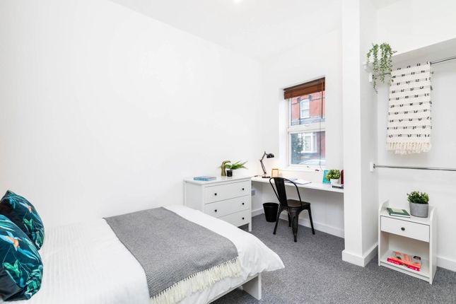 A Bright And Tidy Single Bedroom Featuring A Comfo...