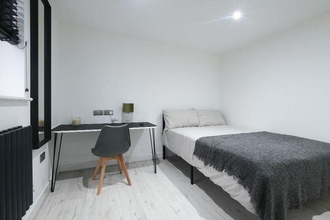 A Modern, Well-Lit Master Bedroom Featuring A Comf...