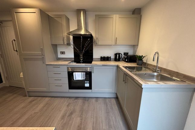 Modern Kitchen Featuring Sleek Cabinetry And Styli...