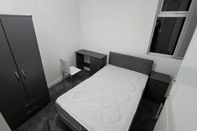 A Simple, Neatly Maintained Bedroom Featuring A Si...