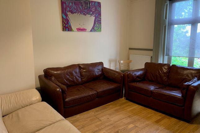 A Cozy Living Room Featuring Two Brown Leather Sof...