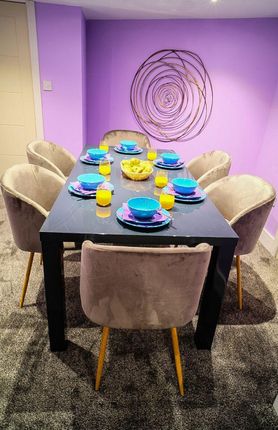 A Stylish Dining Area Featuring A Sleek Black Tabl...