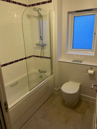 A Modern Bathroom Suite Featuring A Clean White Ba...