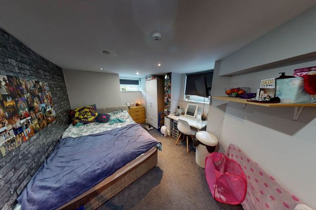 A Cozy And Well-Lit Bedroom Featuring A Spacious B...