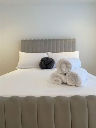 A Spacious And Neatly Made Master Bedroom Featurin...