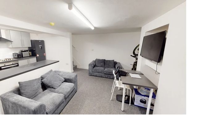 A Modern And Well-Lit Living Room Featuring Comfor...