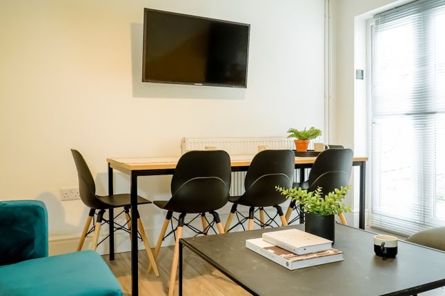 A Modern, Well-Lit Living Room Featuring Comfortab...